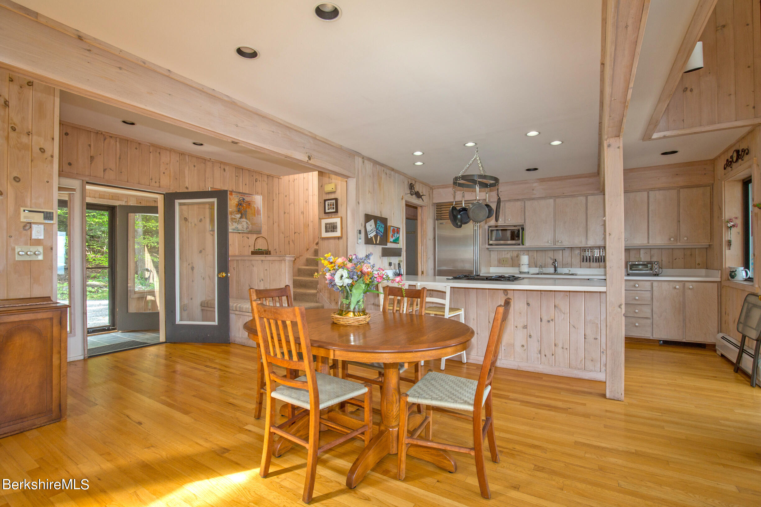 795 Moberg Road Becket, MA 01223 - Photo 5 of 41 a dining room with stainless steel appliances kitchen island granite countertop a table and chairs