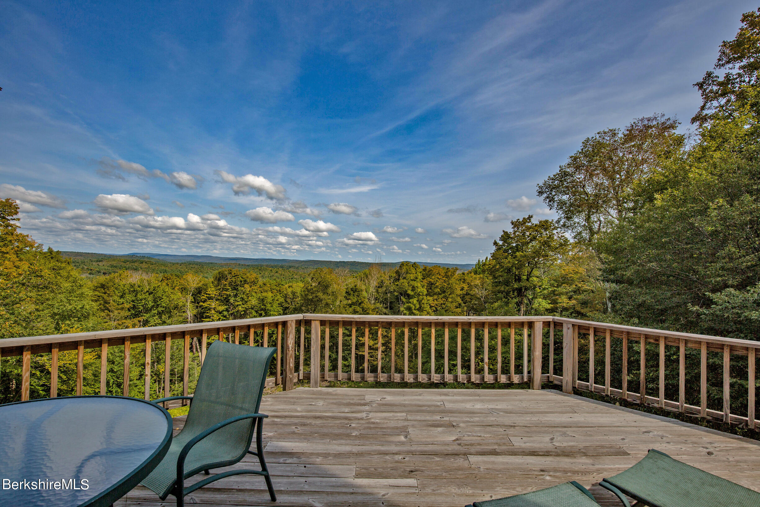 795 Moberg Road Becket, MA 01223 - Photo 8 of 41 a view of a balcony with wooden floor and fence