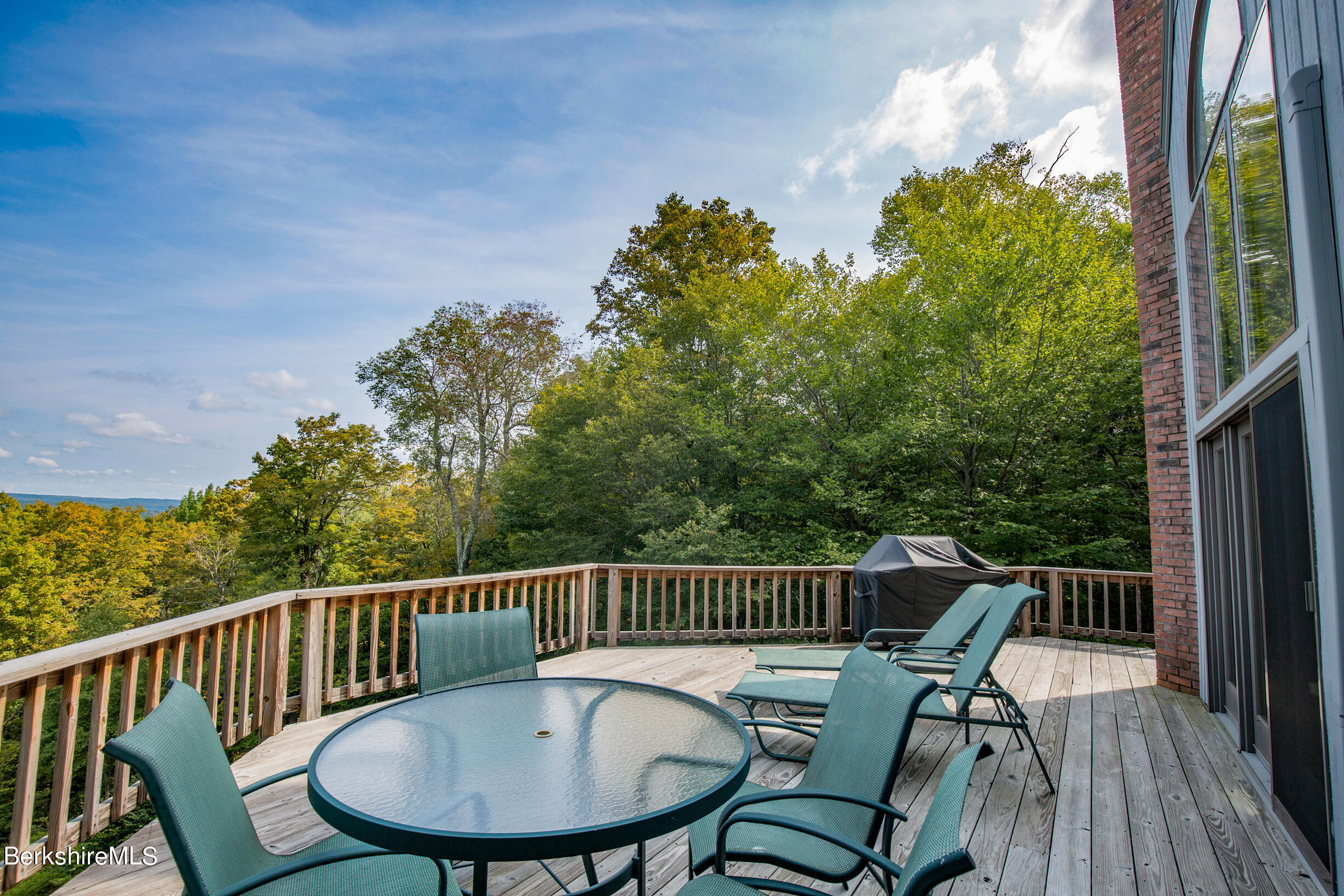 795 Moberg Road Becket, MA 01223 - Photo 9 of 41 a view of a chair and table on the deck