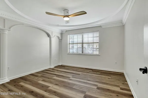 a view of a room with wooden floor and a window