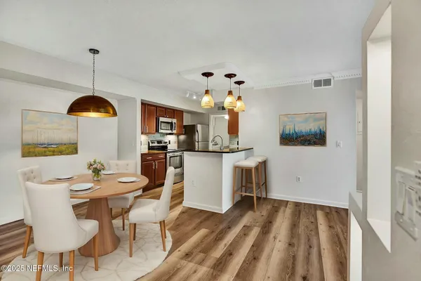 a view of a dining room with furniture and wooden floor