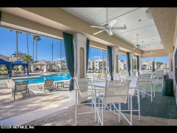 a dining room with furniture and window