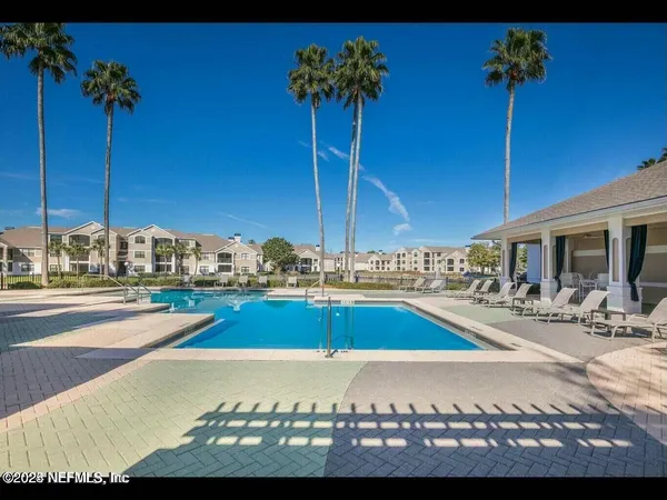 a view of a swimming pool and lounge chair