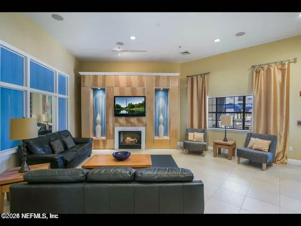 a living room with furniture window and a flat screen tv