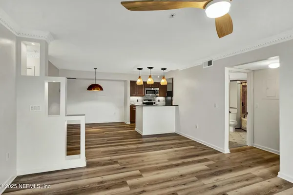 a view of a kitchen cabinets and wooden floor