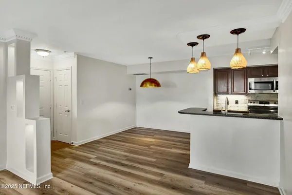 a kitchen with kitchen island a stove and a refrigerator