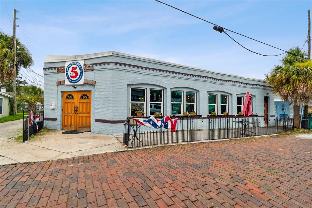 131 Hibiscus Street Tarpon Springs, FL 34689 - Photo 7 of 11 a view of parking with a bench in front of building
