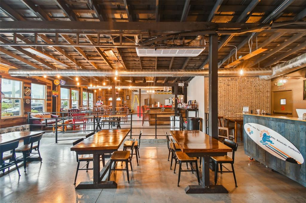131 Hibiscus Street Tarpon Springs, FL 34689 - Photo 9 of 11 a living room with lots of furniture and a view of kitchen