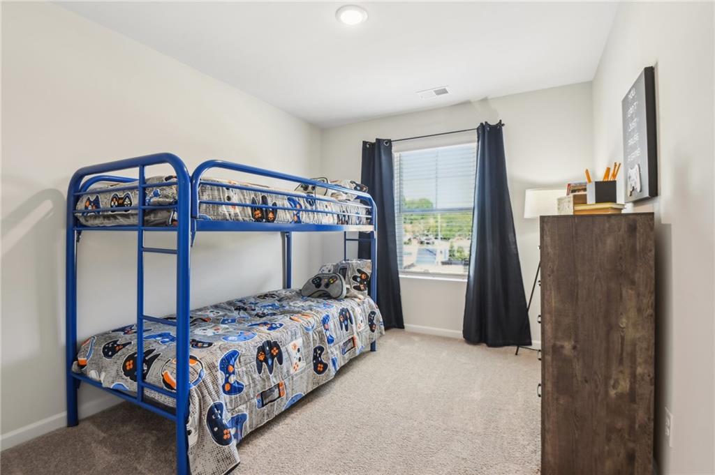 284 Switcher Court Union City, GA 30291 - Photo 28 of 36 a bedroom with a bed next to a window