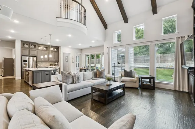 a living room with furniture and floor to ceiling windows
