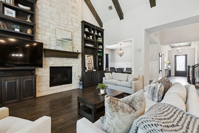 a living room with furniture a flat screen tv and a fireplace