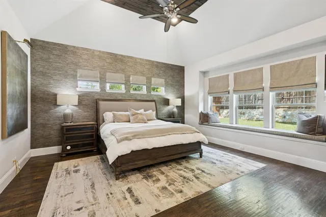 a bedroom with a large bed and a large window