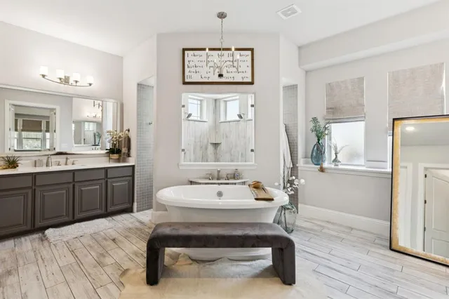 a bathroom with a sink mirror and a window