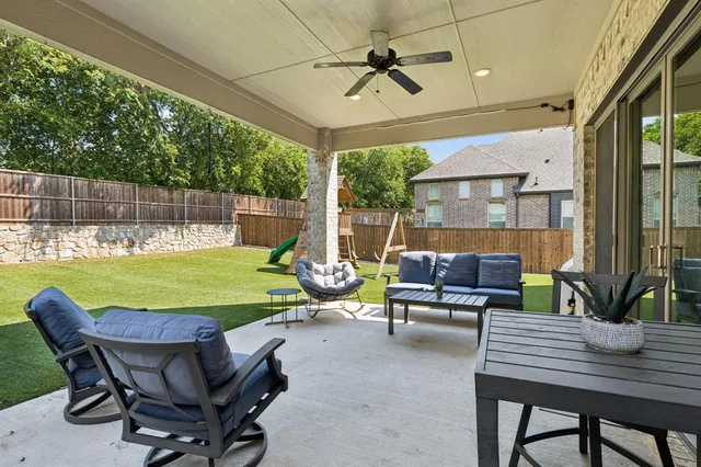 a view of a backyard with a tub and chairs