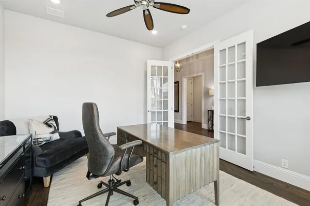 a view of a workspace with furniture and a window