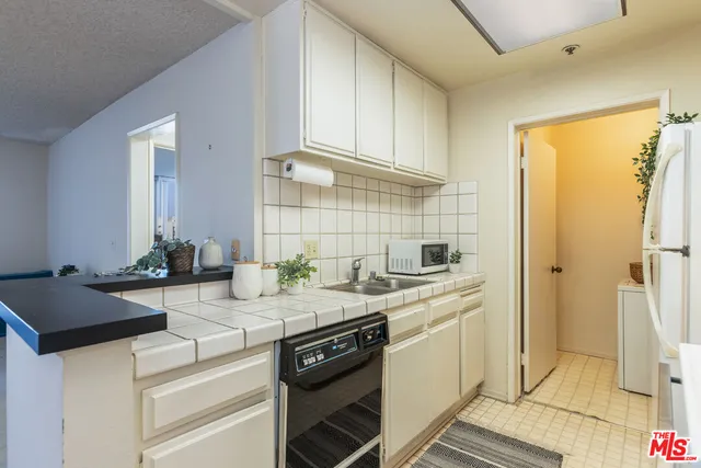a kitchen with a sink stove and refrigerator