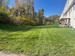 a view of a field of grass and trees