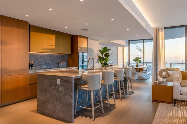 a kitchen with counter top a sink a counter space appliances and cabinets