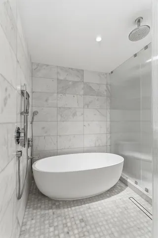 a bedroom with a large window and a bed