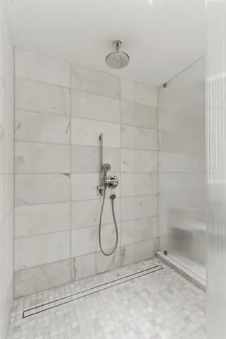 a bathroom with a granite countertop sink and a bathtub
