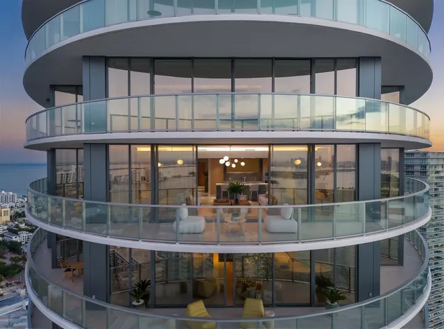 a living room with furniture and potted plants