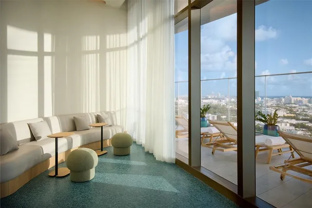 a dining room with furniture and a potted plant