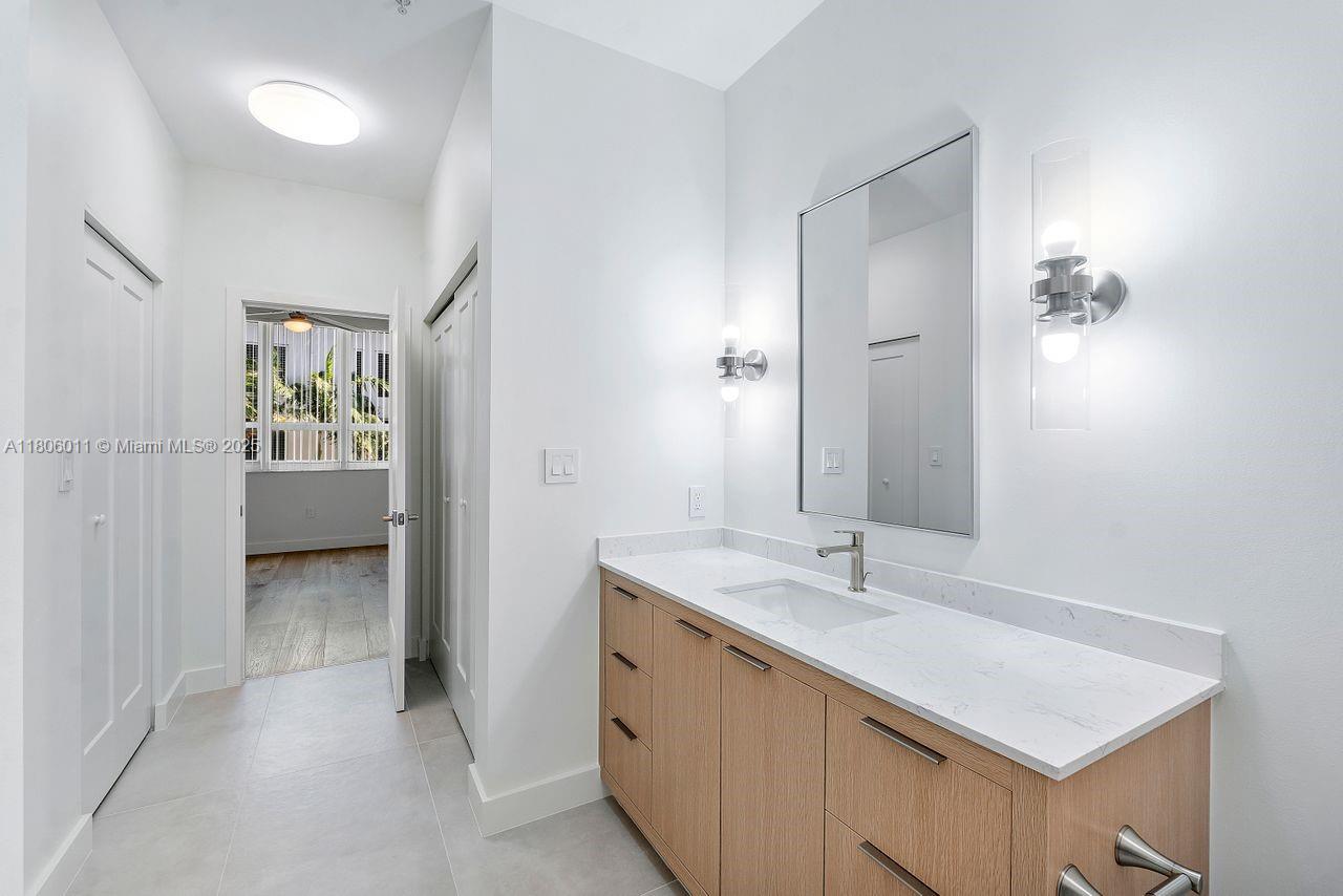 2001 Biscayne Boulevard, Unit 2308 Miami, FL 33137 - Photo 15 of 29 a bathroom with a shower sink and mirror