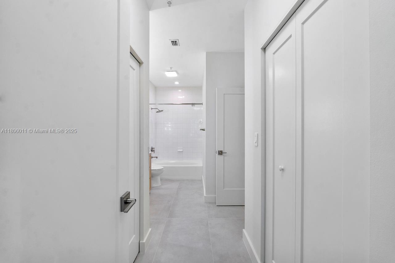 2001 Biscayne Boulevard, Unit 2308 Miami, FL 33137 - Photo 16 of 29 a bathroom with a glass shower door