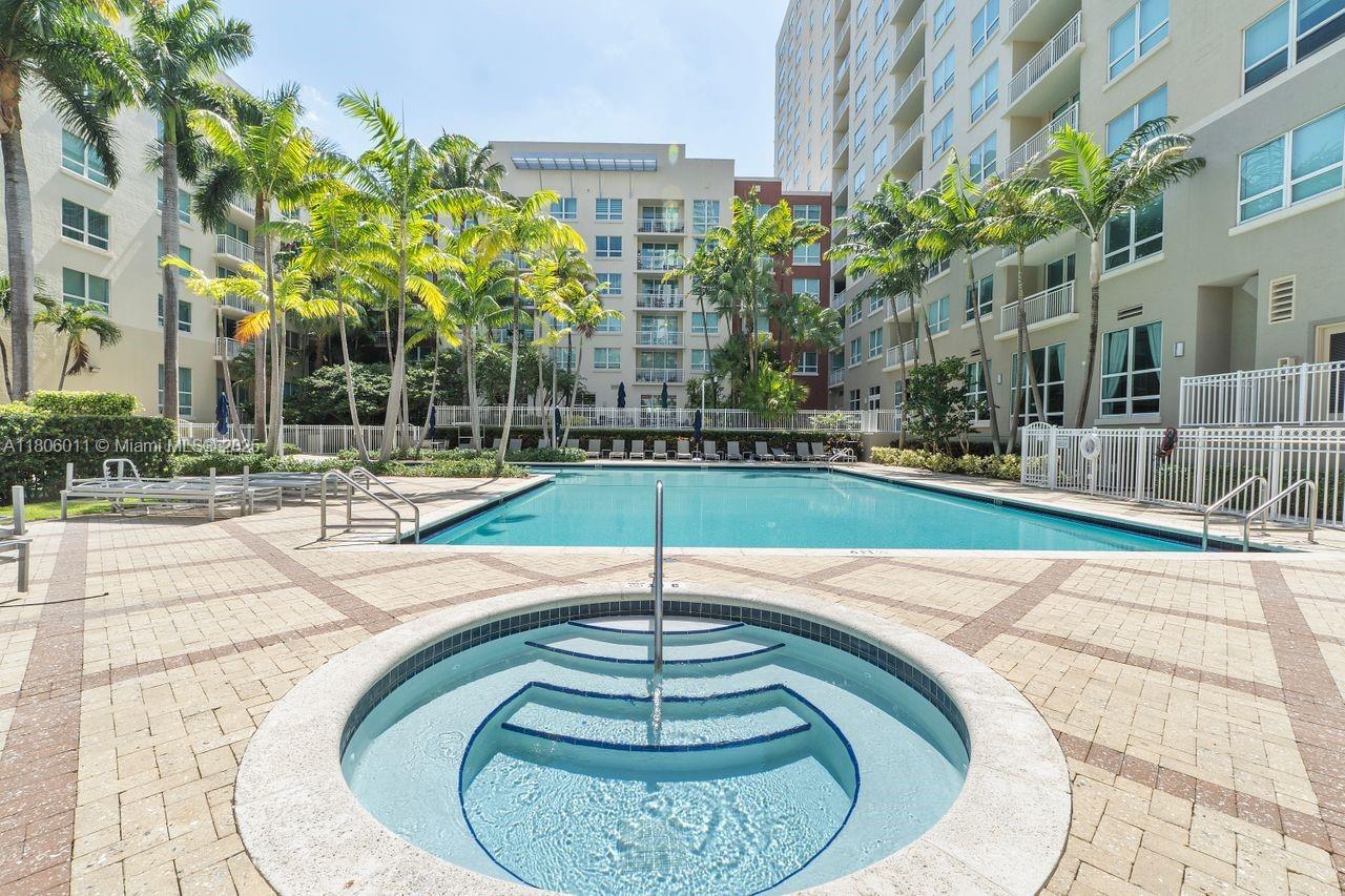 2001 Biscayne Boulevard, Unit 2308 Miami, FL 33137 - Photo 22 of 29 a swimming pool with outdoor space and trees in the background