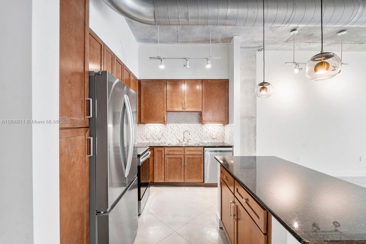 2001 Biscayne Boulevard, Unit 2308 Miami, FL 33137 - Photo 10 of 29 a kitchen with stainless steel appliances granite countertop a refrigerator and a sink