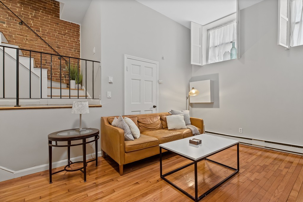 8 Dwight Street, Unit 1 Boston, MA 02118 - Photo 1 of 20 a living room with furniture and a wooden floor