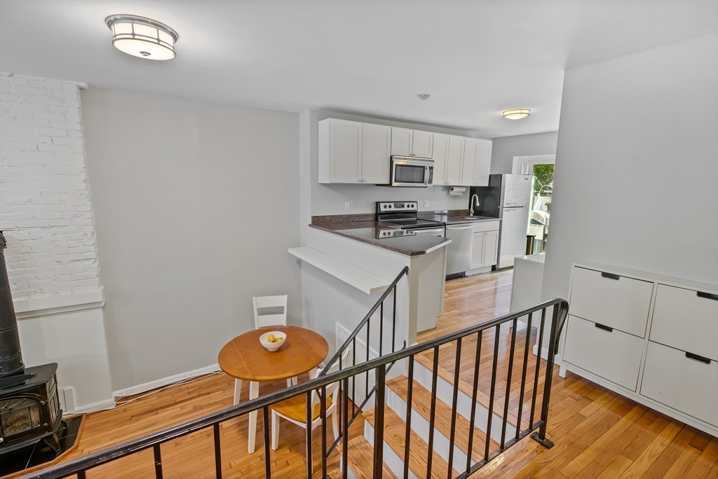 8 Dwight Street, Unit 1 Boston, MA 02118 - Photo 5 of 20 a kitchen with stainless steel appliances granite countertop a stove a sink and a refrigerator