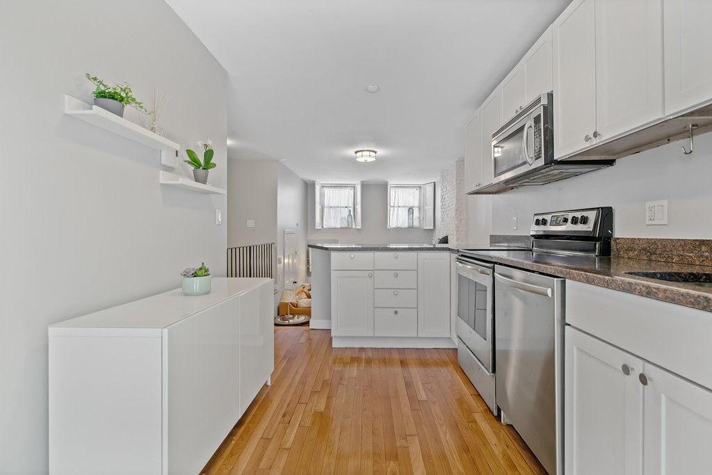 8 Dwight Street, Unit 1 Boston, MA 02118 - Photo 8 of 20 a kitchen with a sink a counter top space stainless steel appliances and cabinets
