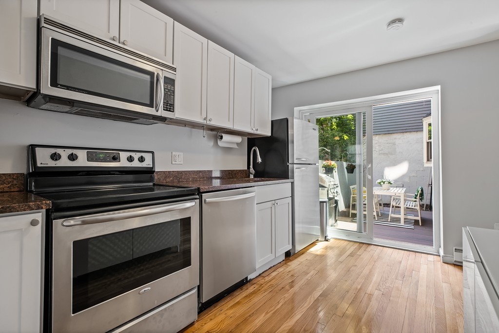 8 Dwight Street, Unit 1 Boston, MA 02118 - Photo 10 of 20 a kitchen with stainless steel appliances granite countertop a stove microwave and cabinets