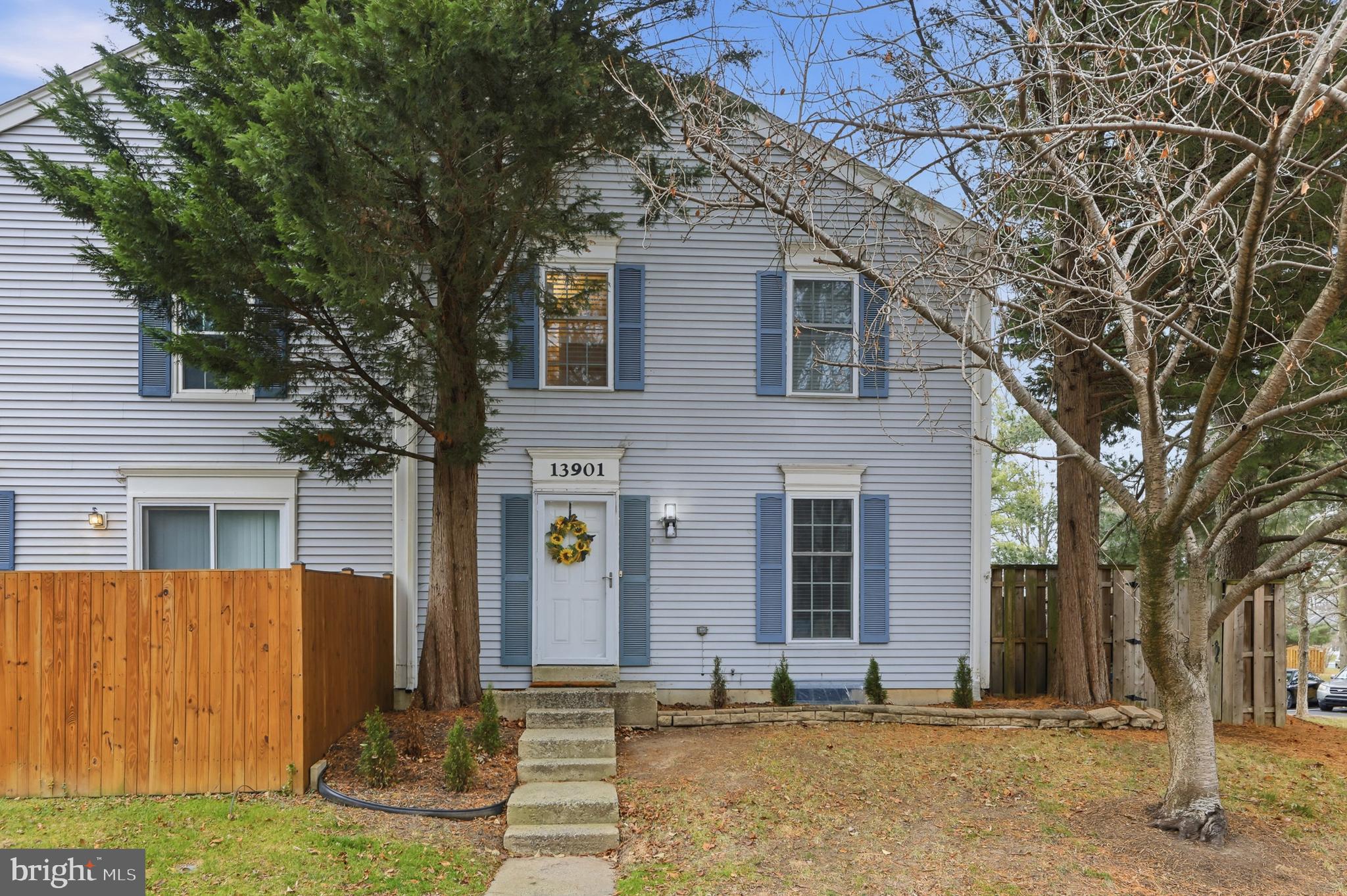 a front view of house with a garden