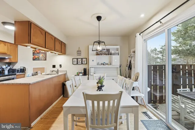 a view of a dining room with furniture large windows and wooden floor