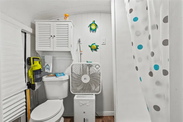 a white toilet sitting next to a bathroom sink