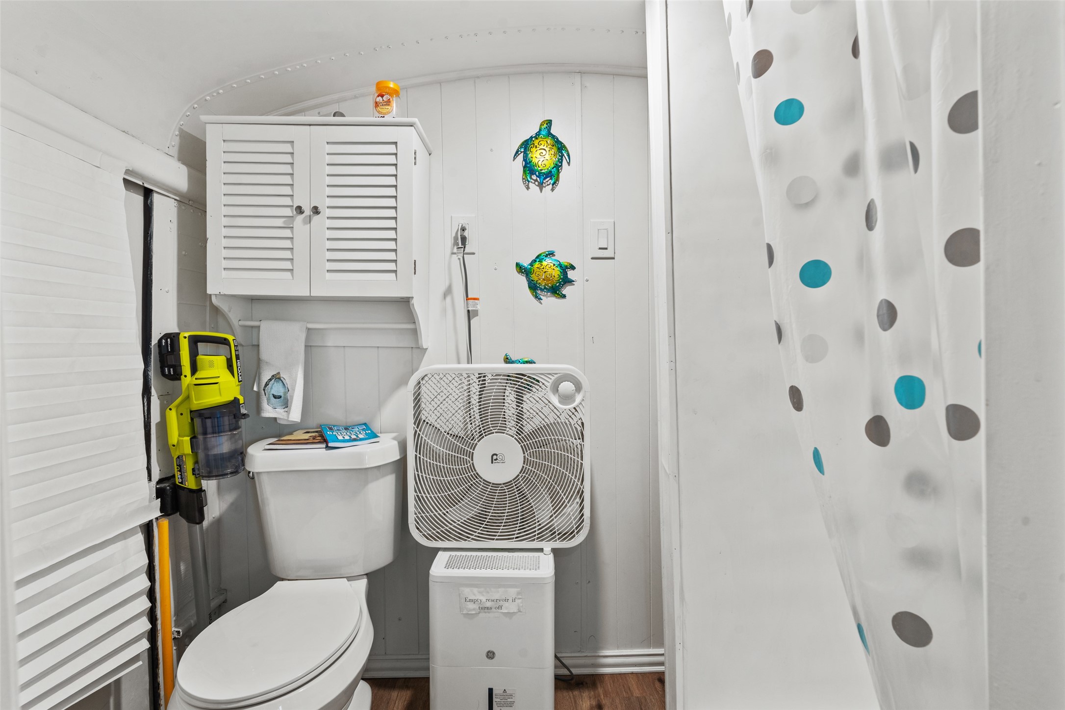 1287 North Crystal Beach Road Crystal Beach, TX 77650 - Photo 15 of 45 a white toilet sitting next to a bathroom sink