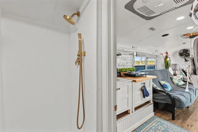 a view of a hallway and a livingroom with furniture