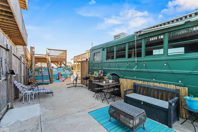 a view of a patio with couches chairs and a fire pit