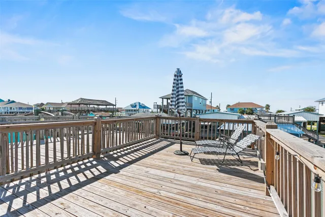 a view of a balcony with wooden floor and fence
