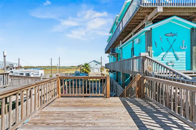 a view of balcony with wooden floor and fence