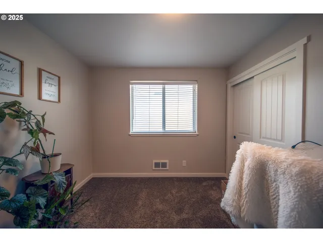 a bedroom with a bed and a tv