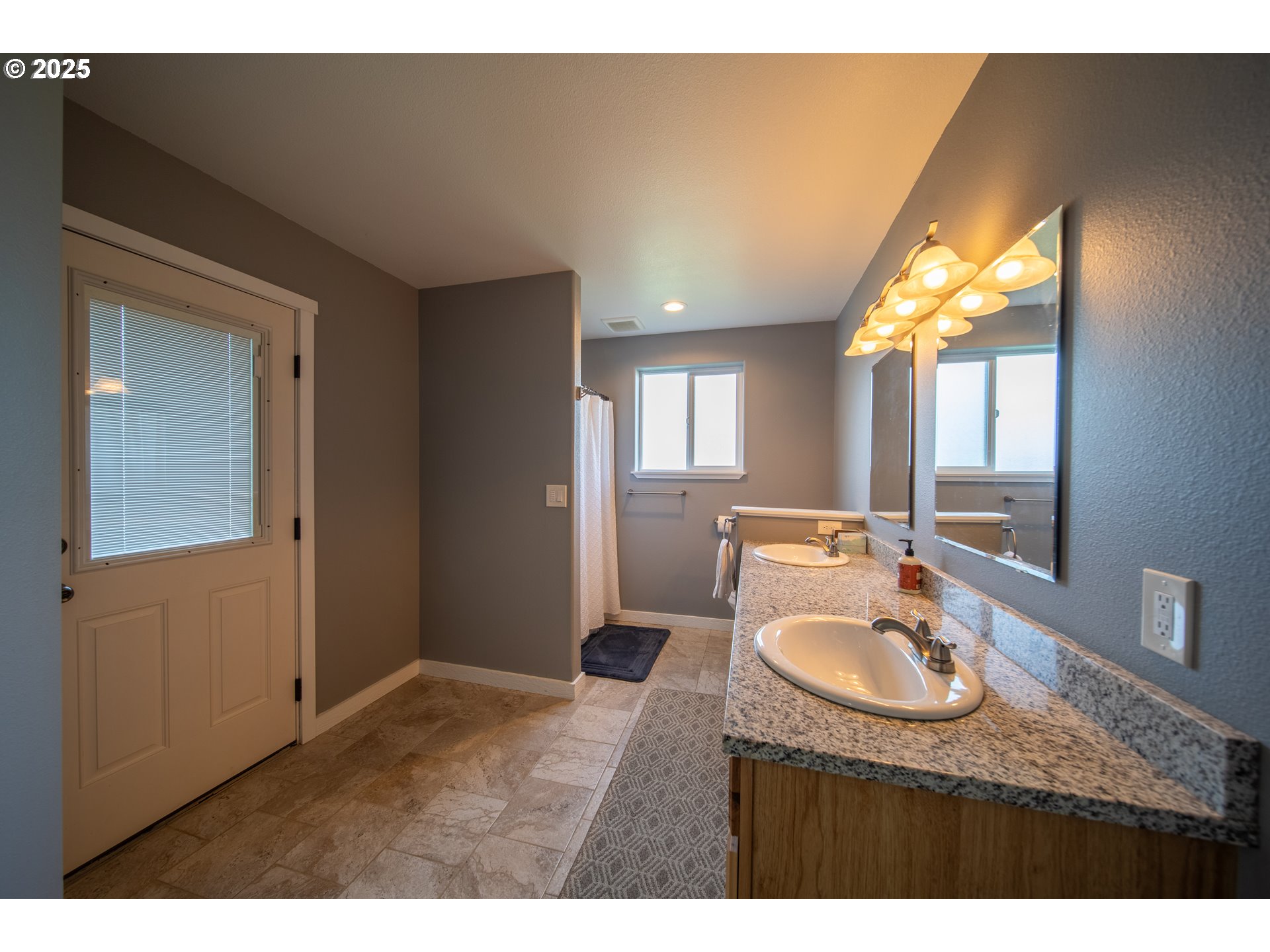 1010 Raechel Road Lakeside, OR 97449 - Photo 32 of 44 a bathroom with a sink double vanity granite and a mirror
