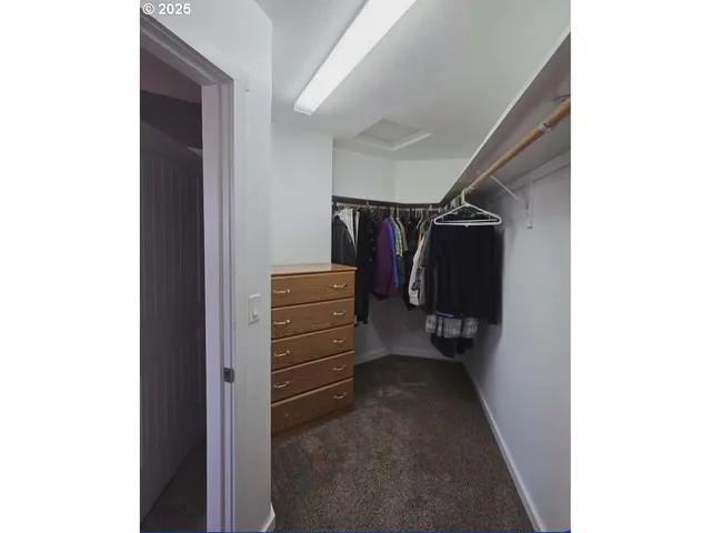 a view of a house with a yard and wooden fence