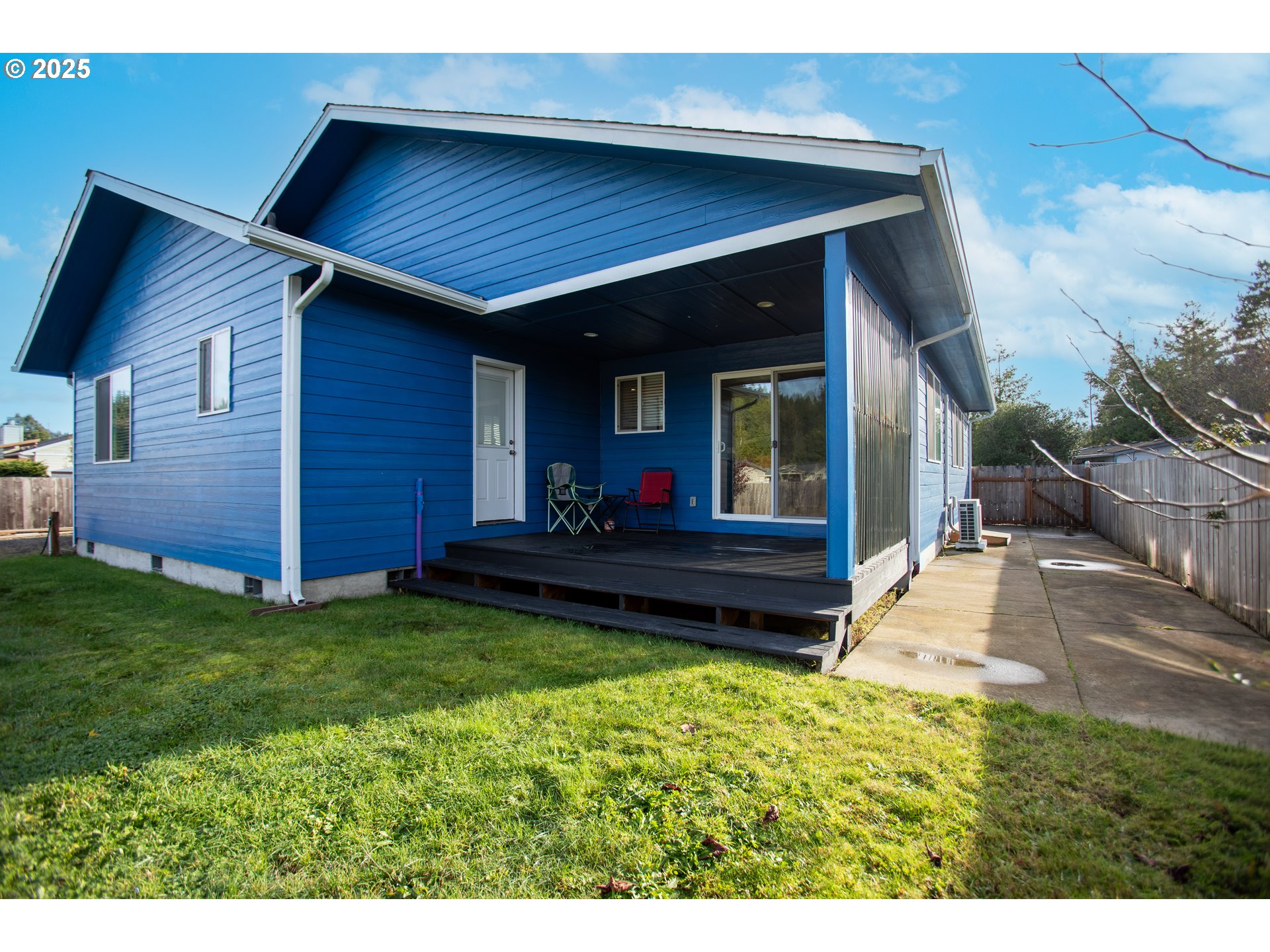 1010 Raechel Road Lakeside, OR 97449 - Photo 34 of 44 a view of a house with a yard and wooden fence