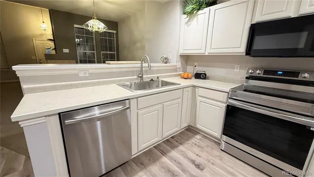 a kitchen with a sink stove and microwave