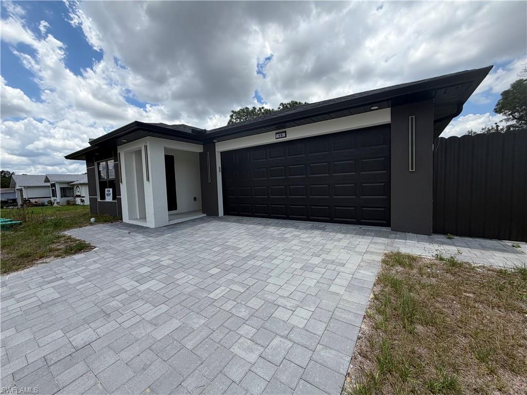 15 Louisiana Road Lehigh Acres, FL 33936 - Photo 1 of 22 a view of a house with a yard and garage