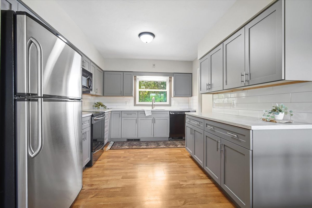 203 Highview Drive Eureka, IL 61530 - Photo 12 of 49 a kitchen with granite countertop a refrigerator a sink dishwasher a stove top oven a refrigerator and cabinets