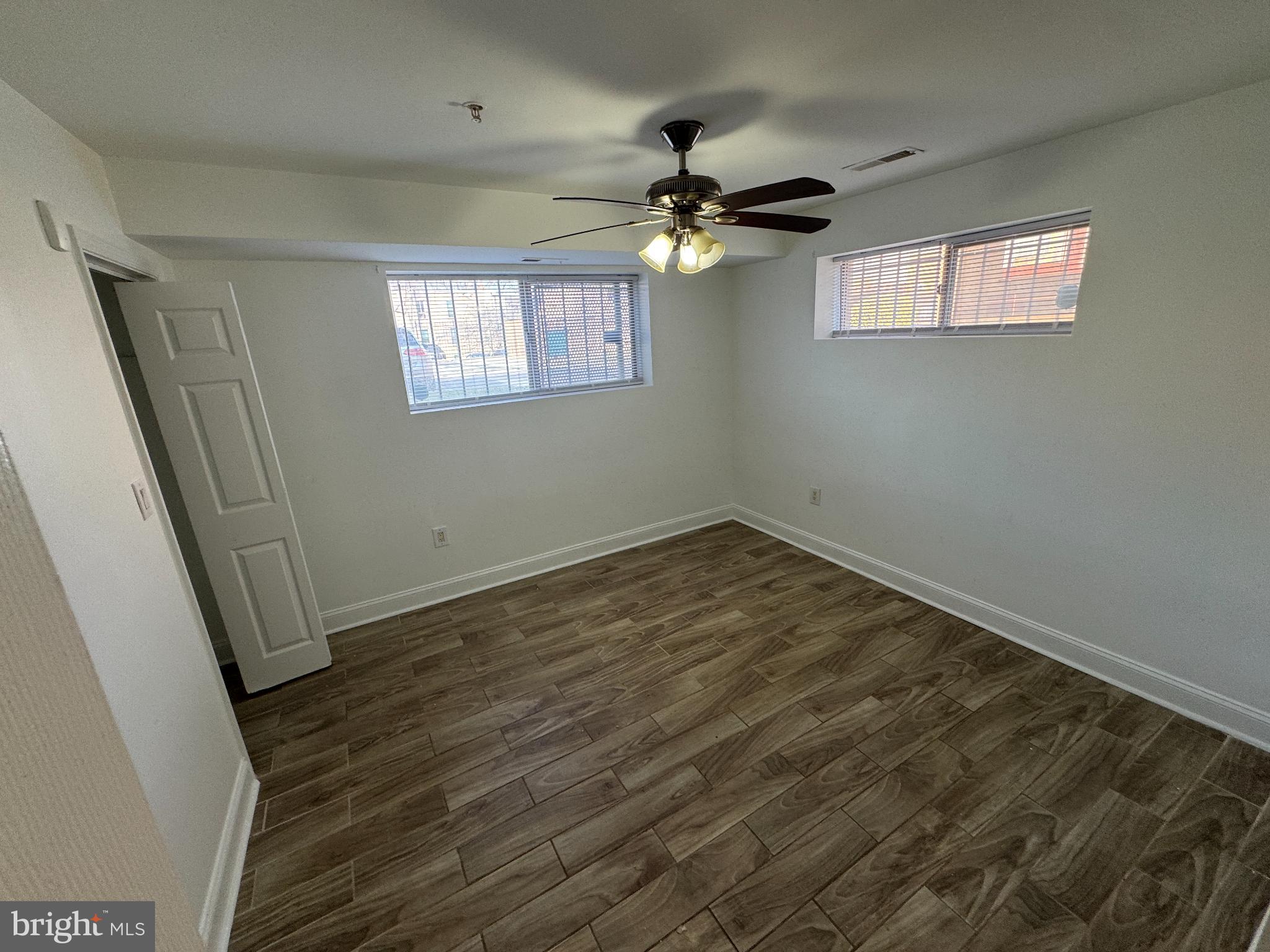 4110 Ames Street Northeast, Unit 14 Washington, DC 20019 - Photo 5 of 7 a view of empty room with wooden floor and fan